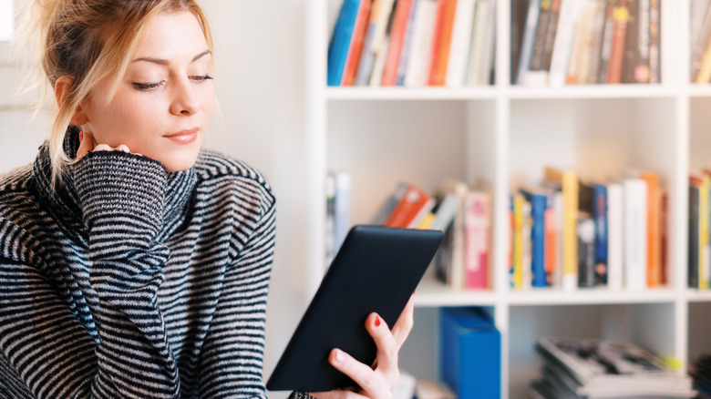 Woman reading Kindle