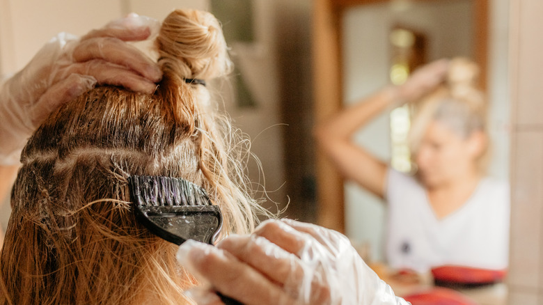 Woman dyeing her own hair