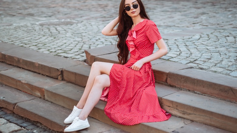 woman wearing sneakers and dress