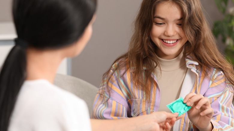 Woman giving a condom