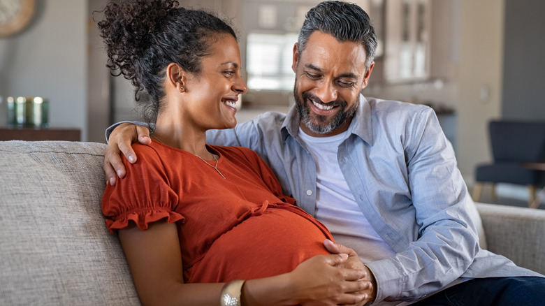 Husband and pregnant wife sitting together