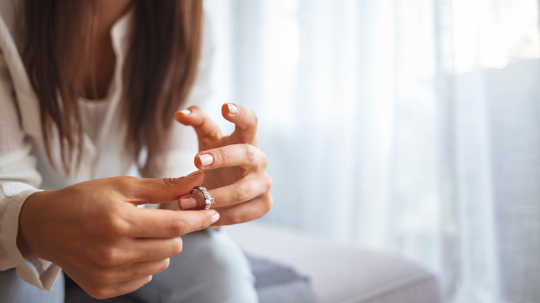 Woman taking off wedding ring