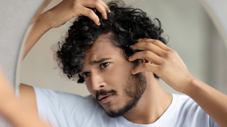 Frowning man worried about hair