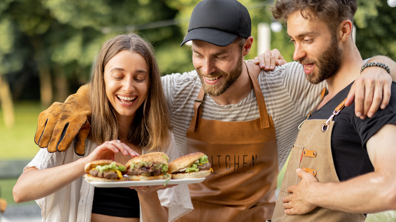 Three friends making burgers 