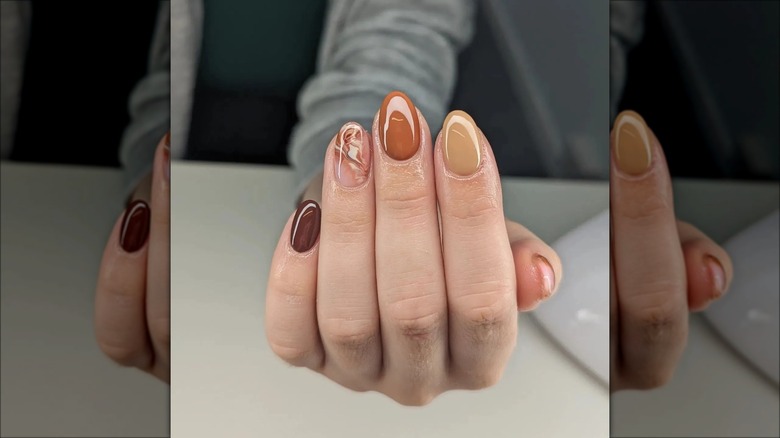 Almond-shaped neutral nail with marble pattern