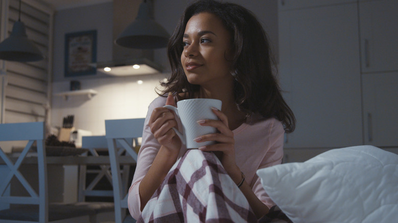 woman in pajamas with a mug