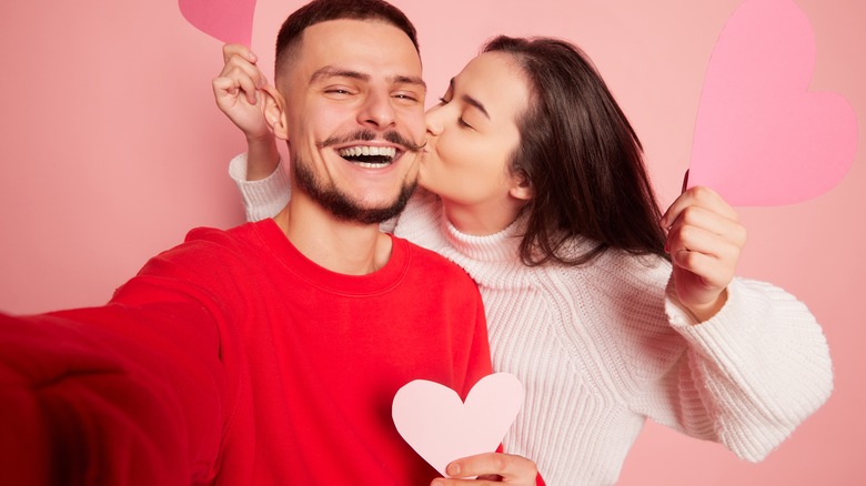 A happy couple showering each other with affection