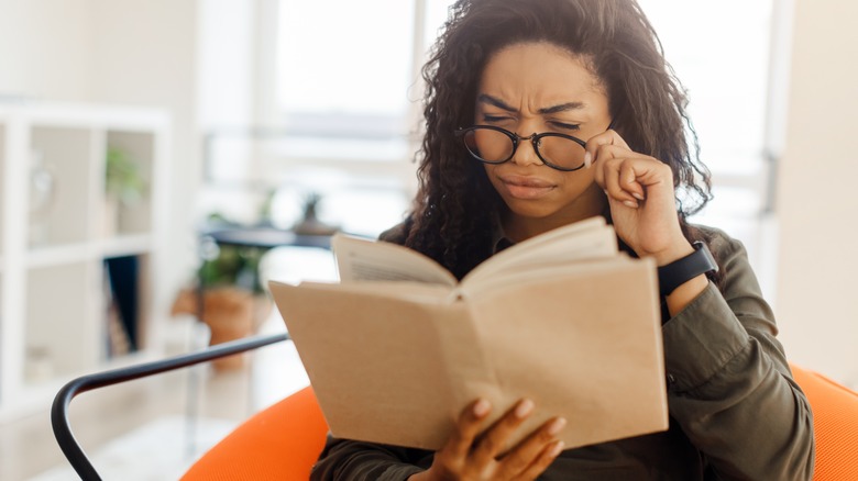 Woman looking suspiciously at something she's reading