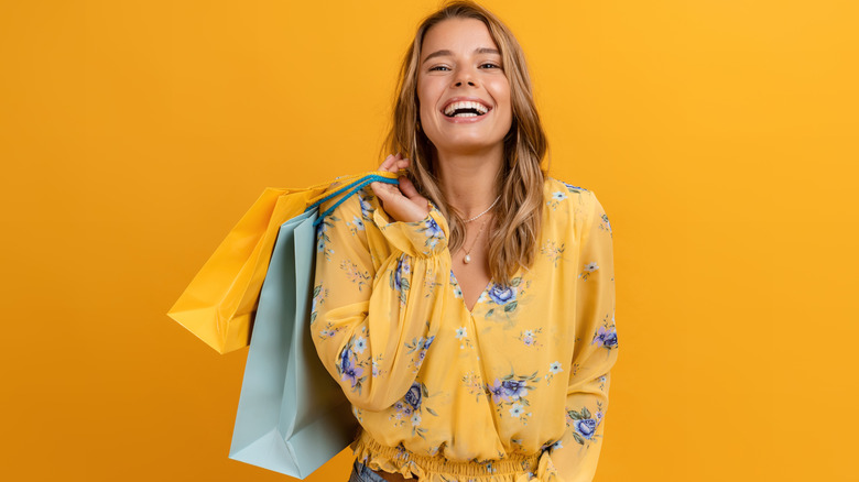 Smiling woman holding shopping bags