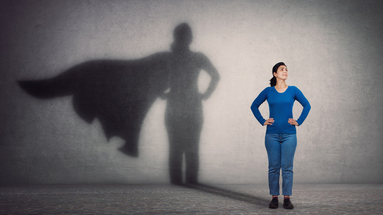 Woman pictured with a superhero shadow