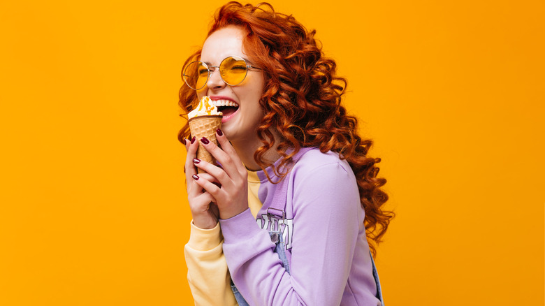 Laughing woman holding an ice cream cone