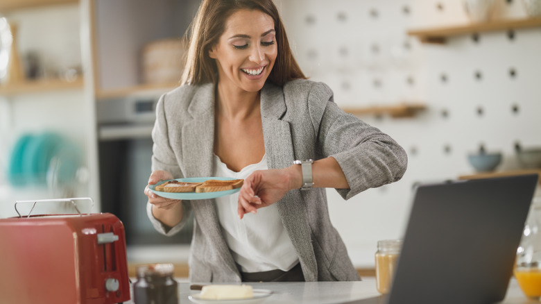 woman on the go in the morning having toast