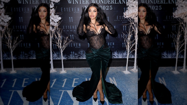 Cardi B in a black and green dress for New Year's Eve