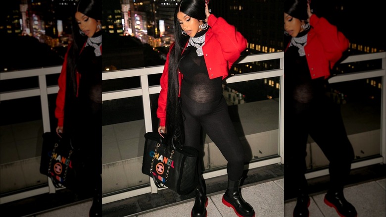 Pregnant Cardi B wearing black and red