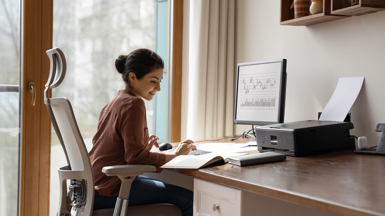 Woman doing work at her desk using desktop computer