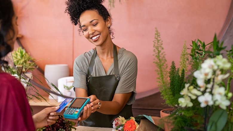 Smiling woman working at florist