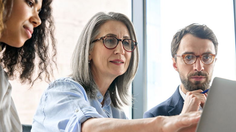 Mature woman sharing data with colleagues