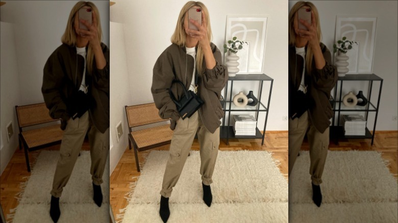 woman wearing neutral outfit in mirror
