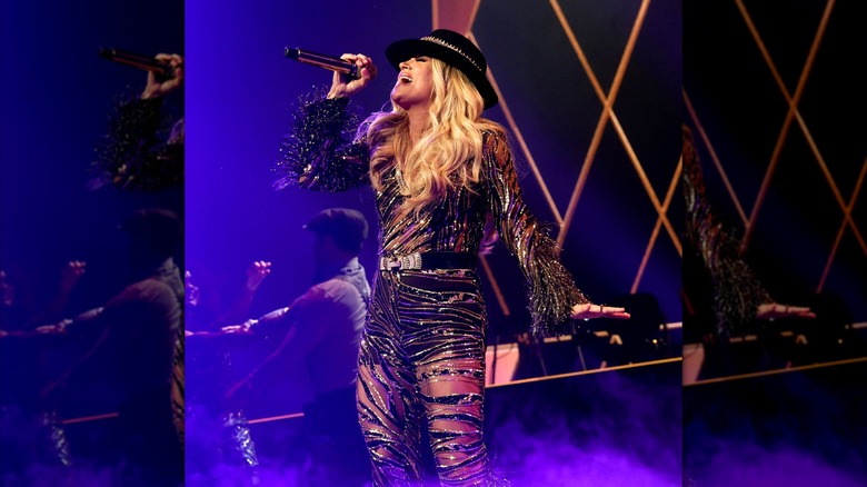 Carrie Underwood wears a bodysuit with sheer cutouts during a show in Las Vegas.