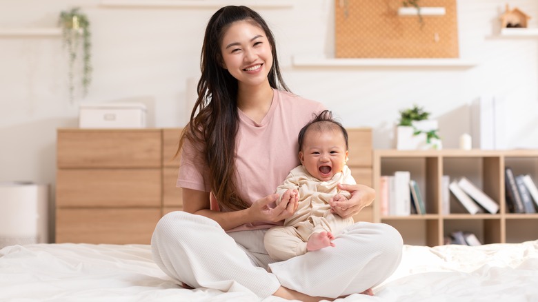 smiling woman and baby