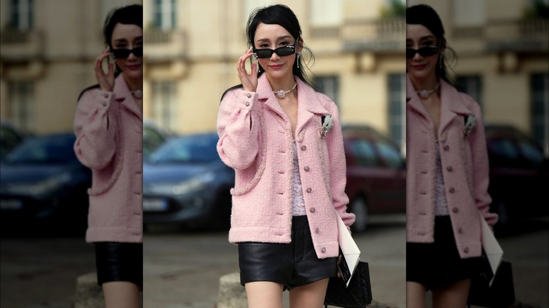 Woman wearing pink tweed jacket and leather skirt