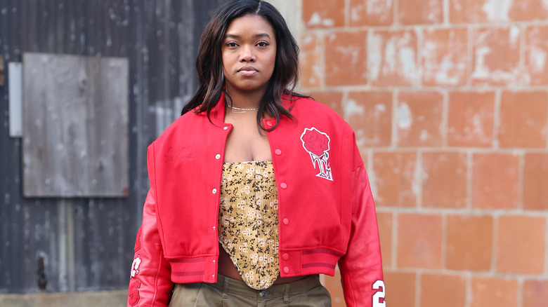 Woman wearing red varsity jacket