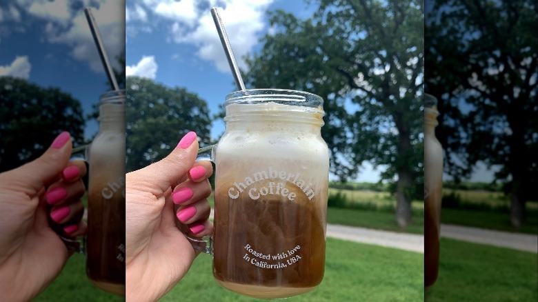 Influencer holding mug of Chamberlain Coffee