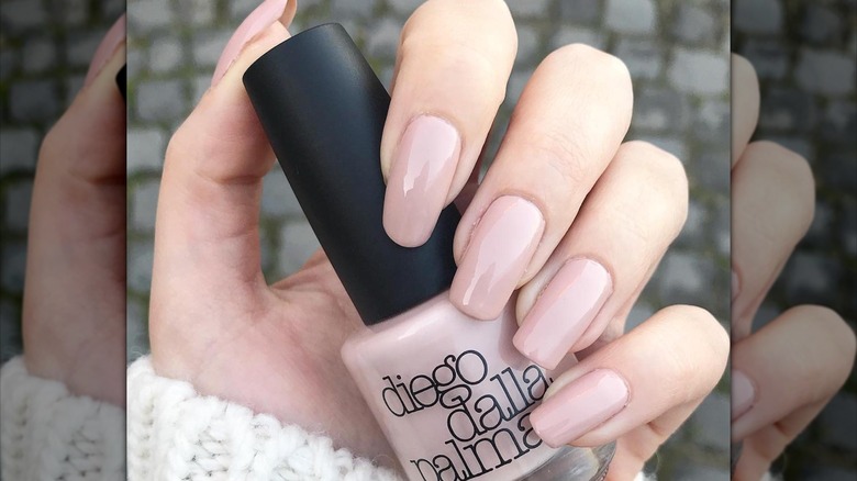 long nude nails holding polish