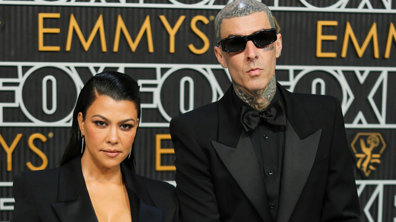 Kourtney Kardashian and Travis Barker walking the Emmys red carpet in all black