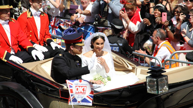 Meghan Markle and Prince Harry on their wedding day in a carriage