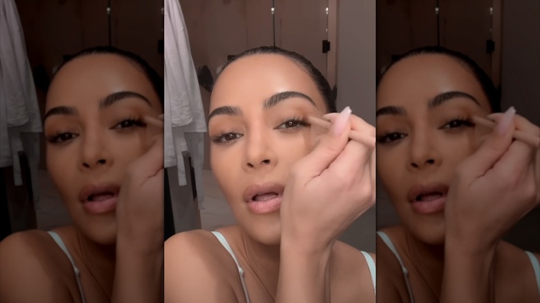 Kim Kardashian contours her eye in a makeup tutorial.