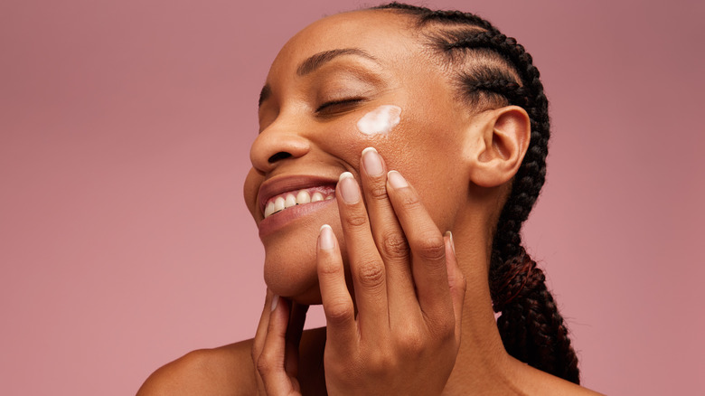 woman applying face cream