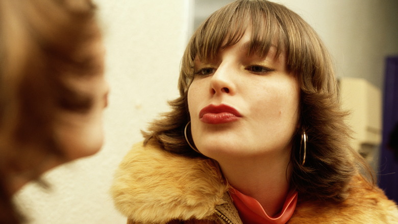 Woman admiring herself in mirror