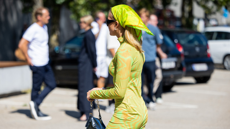 Woman wearing chartreuse scarf, dress