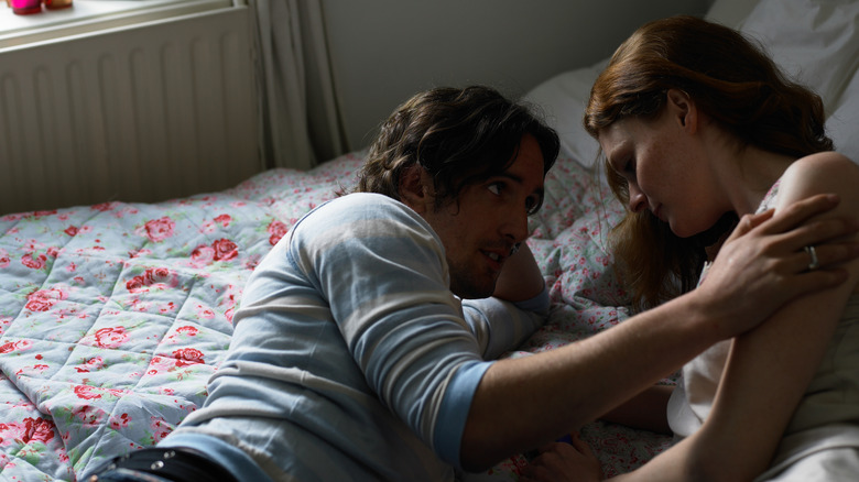 couple talking on bed