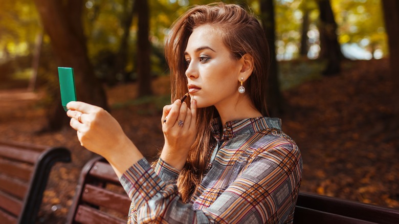 Woman using lip liner