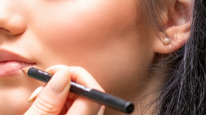 woman applying lip liner