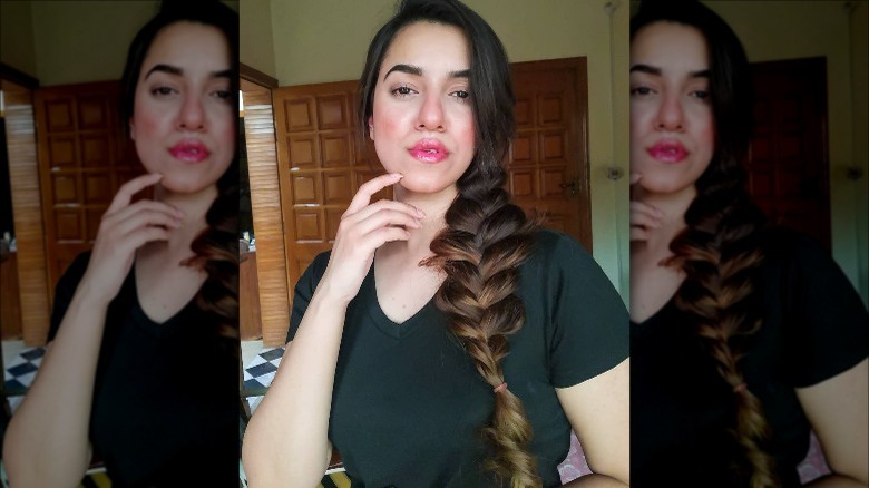 A woman with a messy side braid