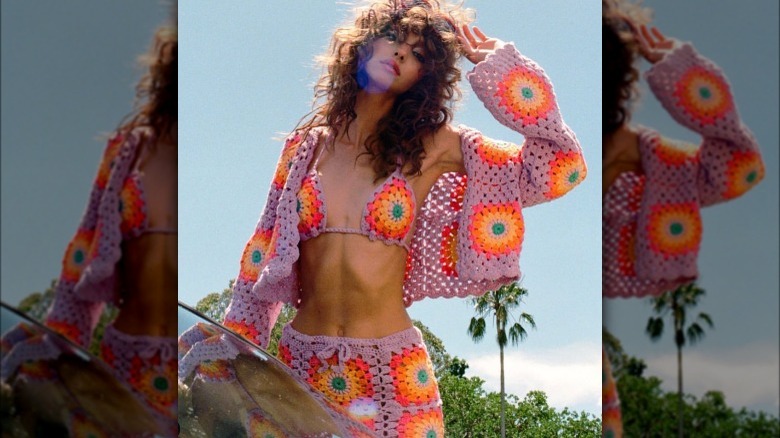 Woman in colorful crochet outfit