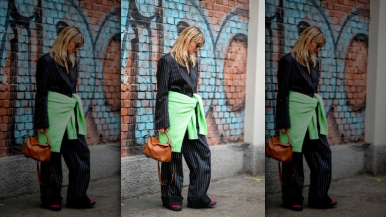 woman with sweater around waist