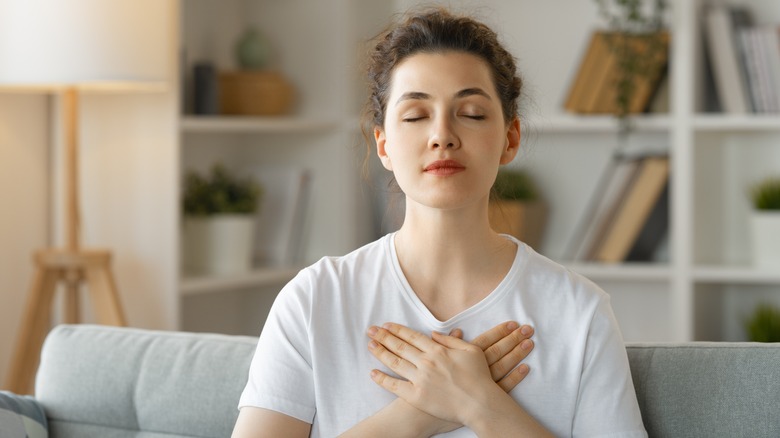 Woman meditating on couch