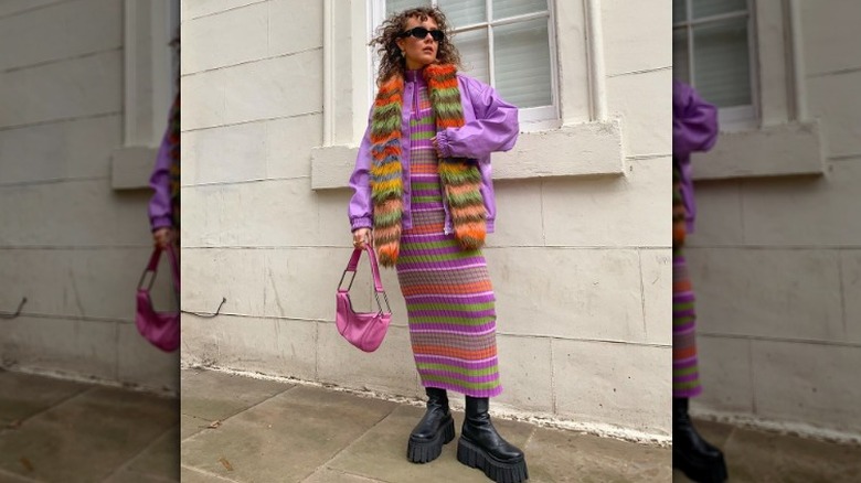 woman wearing chunky boots with a colorful outfit