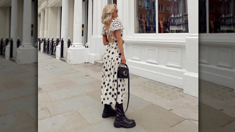 woman wearing chunky boots with a maxi dress