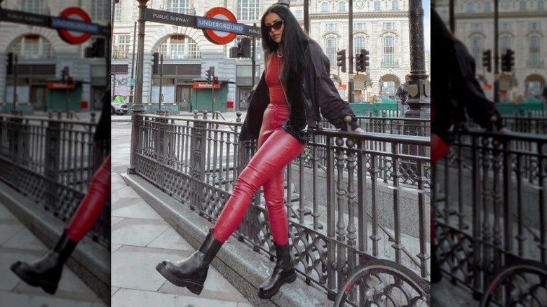 woman wearing chunky boots with faux leather pants