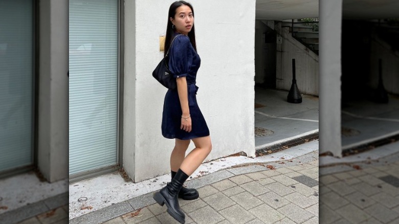 woman wearing chunky boots with a mini dress