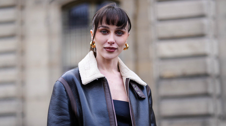 A woman wearing gold hoops