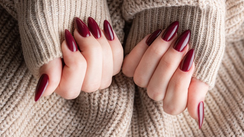 Burgundy manicure and taupe sweater