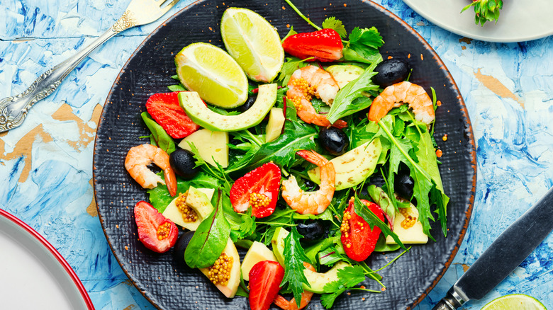 bowl of salad with vegetables and shrimp on top