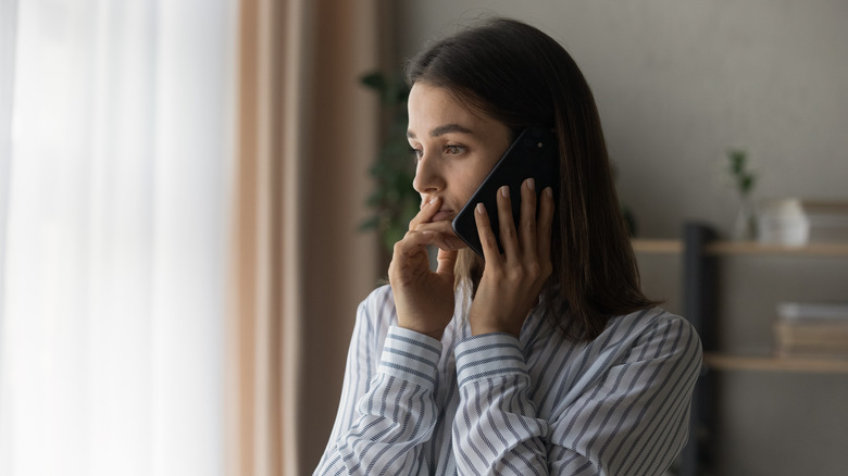 woman holding phone to ear