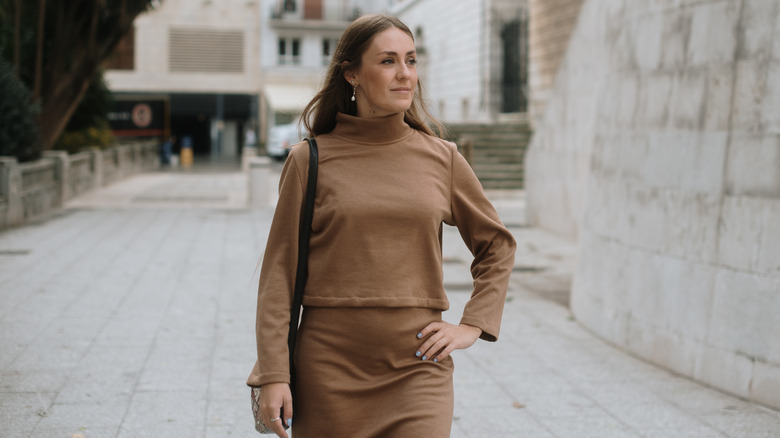 A woman wearing a brown outfit